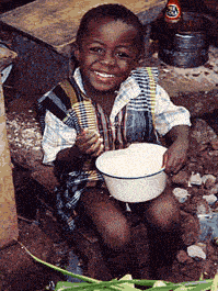 A boy enjoys lunch at a homestay in Ghana.
