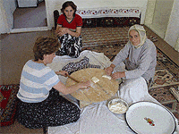 Women of the Serim family preparing 'pufburek' for lunch. Catherine Stryker photo.