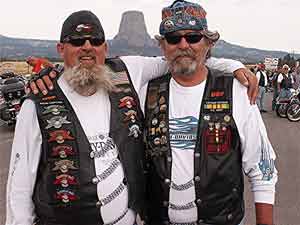 Harley enthusiasts pose in front of Devil's Tower, made famous in 'Close Encounters of the Third Kind.' Photo by David Rich