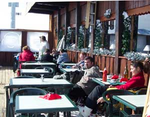 Some hearty souls brave a brisk wind to enjoy a meal deckside at Le Signal overlooking the mountains.