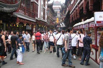 Crowded street scene in China, where you need a visa to enter.