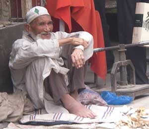 A man selling wooden spoons