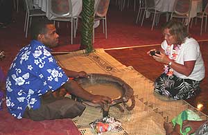 A tribal chief in Fiji shares kava with a visitor.