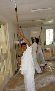 Noor Che'ree helps paint the inside of a school in Poland.