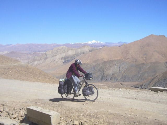 Cycling on the barren Tibetan plateau, near Mount Everest.