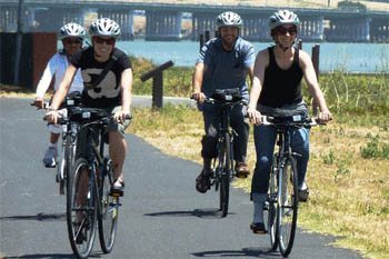 Bikers enjoy a beautiful ride through the urban beach town of Oakland, California