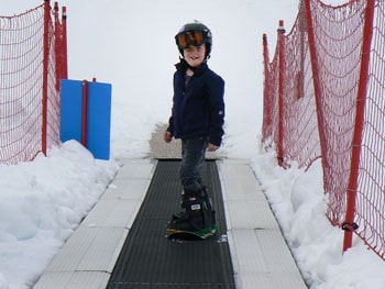 Aboard the Magic carpet at Snowbasin, where little kids learn to snowboard.
