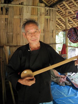 This Lisu Hill Tribesman charmed me with a song on his homemade instrument.