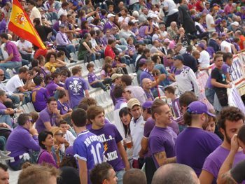 Soccer fans decked out in the Florence team's purple color in the stands