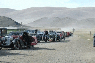 At the border of China and Mongolia, some of the classic cars in the race await their turn to cross. 