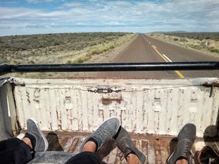 Hitching a ride from Trelew to Esquel, Argentina, on the back of a farmer's truck watching the pampas fly by.
