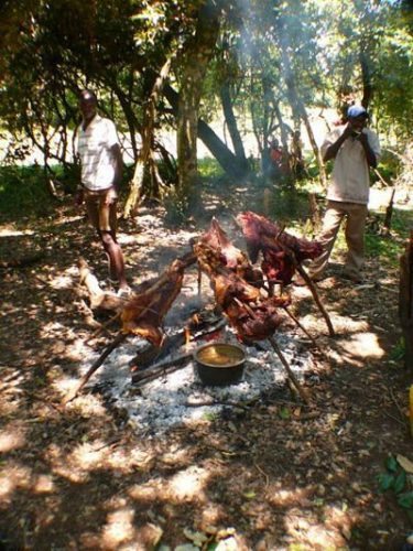 Grilling meat in the jungle with Maasai men. Rene Bauer photos.