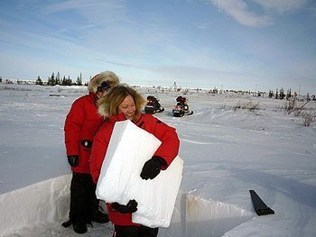 Travel writer Kim Schneider helps build an igloo.