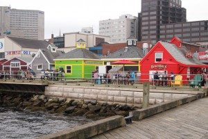 Halifax waterfront features a 3 kilometer boardwalk and ships.