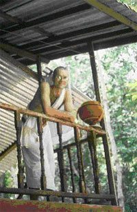  The author in the phakao robes of a "temporary" monk on the balcony of his hut in the jungle.