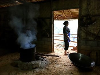 Hmong women cooking in one of their houses.