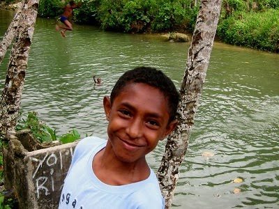 Friendly local at a swimming hole in Fak-Fak, West Papua. photos by Michael Britton.