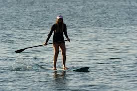 A solo woman paddler.