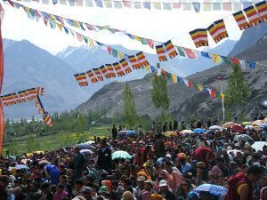 Prayer flags flutter high over the gathering crowd in Ladakh, in the Himalayas. photos by Katherine Smith.