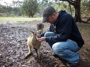 Lee Abbamonte feeding wallabees in tasmania