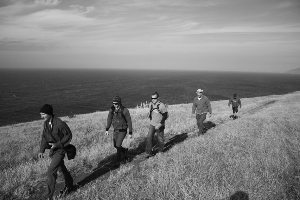 HIking a windswept hillside in California's Channel Islands.