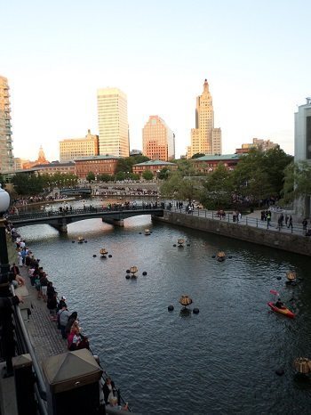 Preparing for the WaterFire Festival lighting at sunset.