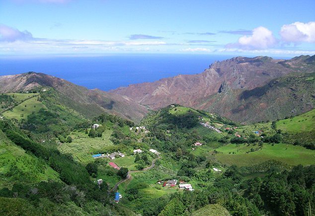 The rolling green vegetation covers the large volcanic mountains 