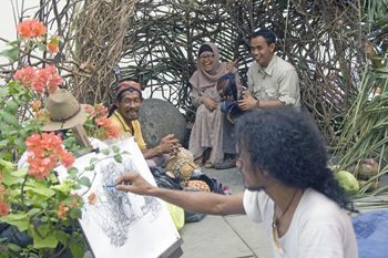 An artist does a portait in Jakarta Kota. photos by Mike Smith, Asia Photo Stock.