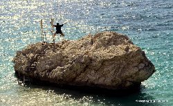 Jumping off a rock on the Albanian coast.