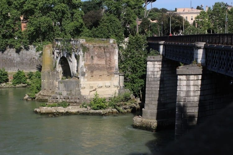 19th century Ponte Palatino next to the single-standing arch of the broken Ponte Rotto (originally Ponte Emilio), south of Isola Tiberina Island in the Tiber
