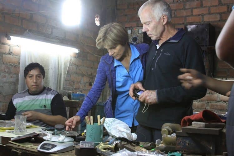 Visiting a silversmith in Lima's slums.