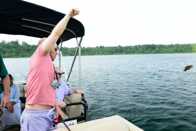 Writer Dave Golokhov throwing the fish he caught back into the water in Massena.