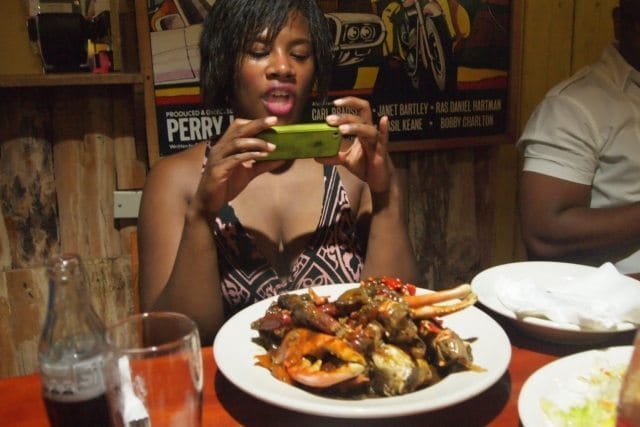 Enjoying a plate of jamaican jerk and seafood.