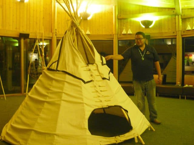 Christopher Standing shows how traditional tipis are constructed at the Wanuskewin Heritage Park.