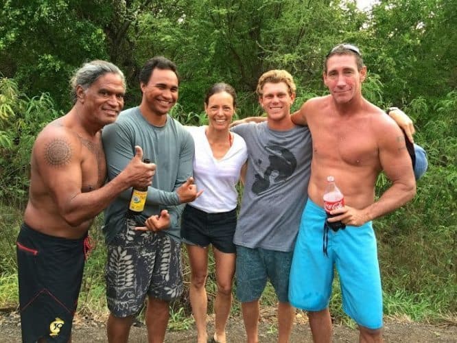 Noelle Salmi relaxes with Titus Kinimaka Kaimi Kaneholani Ry Cowan and Clay Wolcott after surfing at Pakalas Kauai HI. Photo by Suzie Black