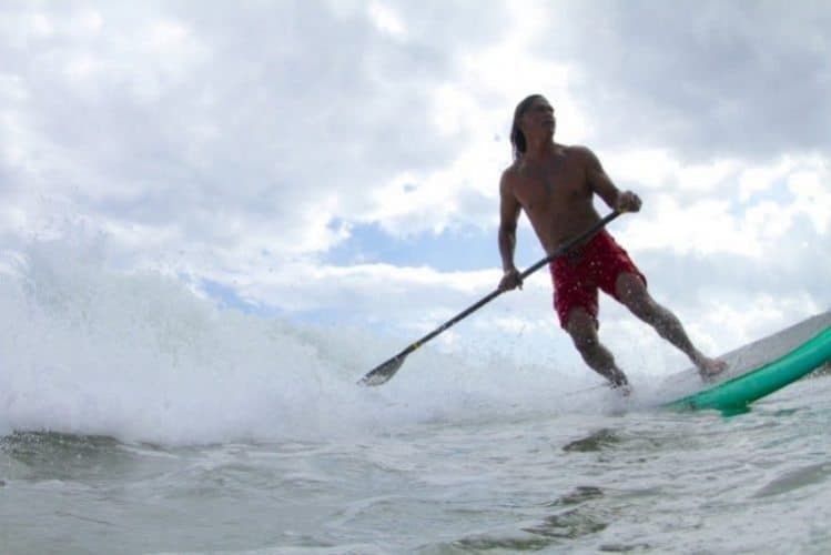 Titus Kinimaka in command of his stand up paddle at Hanalei Bay Kauai HI. Photo by Ry Cowan