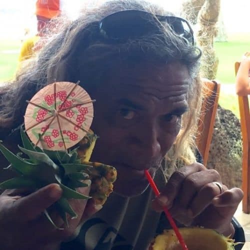 Titus Kinimaka takes a sip of pina colada at Dukes Restaurant Lihue Kauai HI. Photo by Noelle Salmi