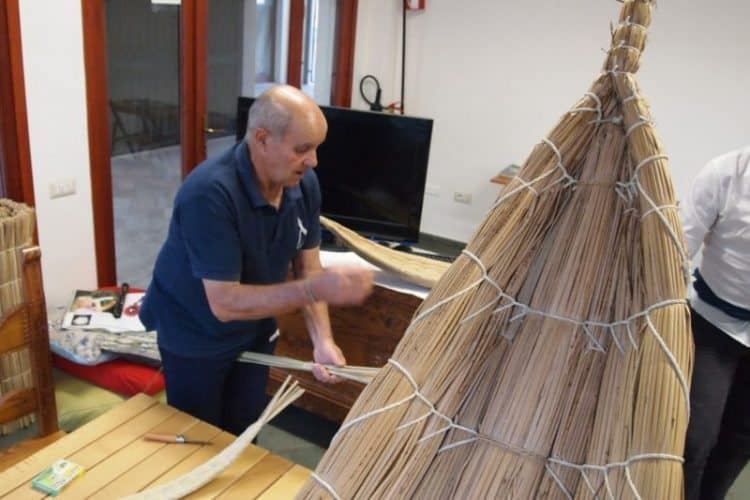 Fassonis are fishing boats made of woven reeds that were once used to fish for mullet in Cabras, Sardinia. Here a fisherman makes a small toy replica.