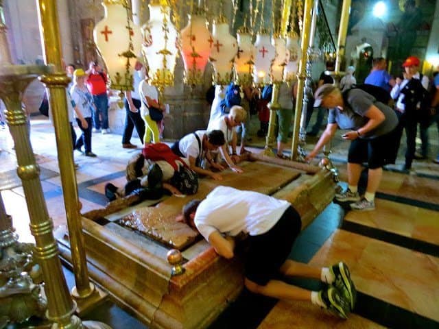 People praying in The Church of the Holy Sepulcher.