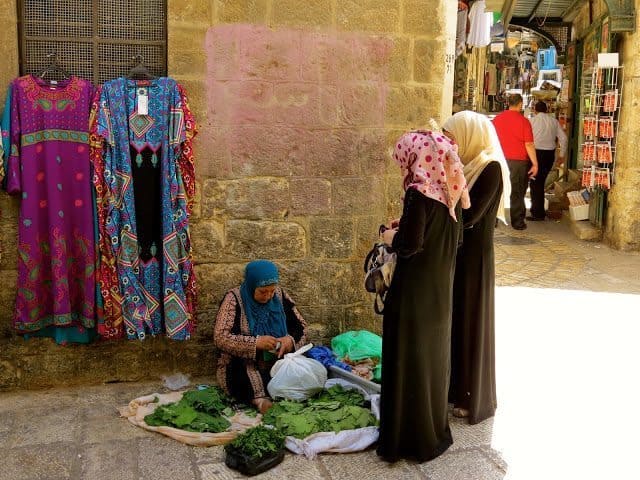 A woman in the Muslim Quarter making grape leaves to sell. 