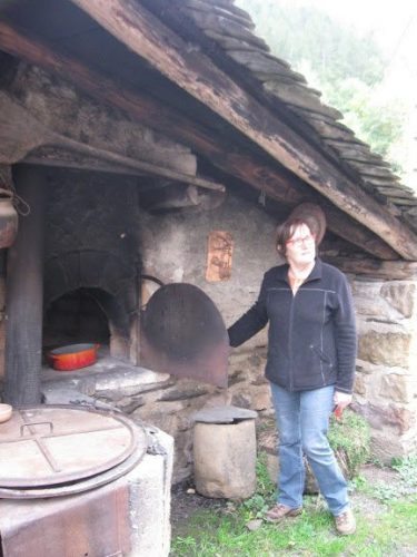 Monique Fraissinet shows us a wood-fired oven, still used today.
