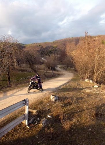 A lonely motorbike and rider along the tracks.