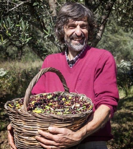 Nature guide Claudio Speroni with a basket of fresh picked olives.