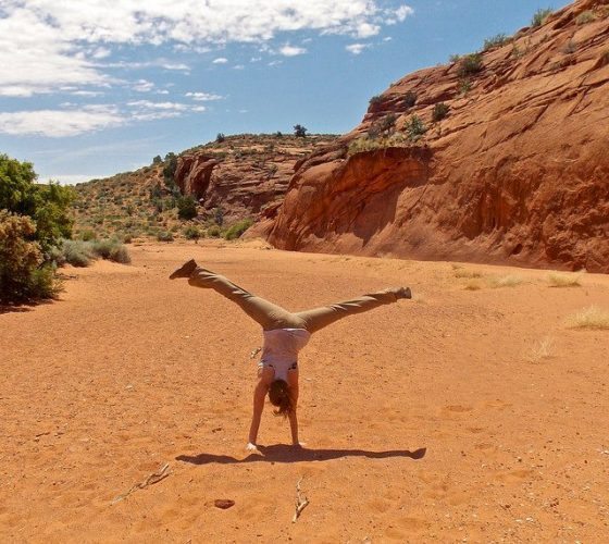 Maisie Schwartz cartwheeling after hiking the Peek-A-Boo and Spooky slot canyons on the Grand Staircase-Escalante National Monument.