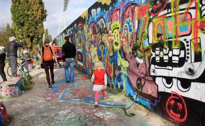 Color and youth fill the streets of Berlin where parts of the infamous historic Cold War Berlin Wall still stand. 