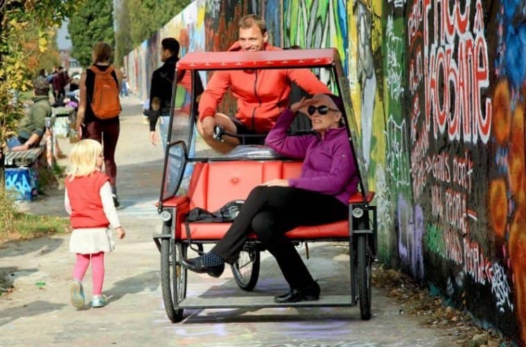 See Berlin from a bike, rickshaw, or even a bed.