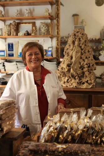 Mireille Oster, owner of a gingerbread shop in Strasbourg, greets guests with a warm smile in the Petite France historic quarter of the city of Strasbourg, France.