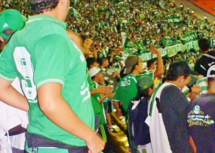 Estadio Atanasio Girardot, full of green and white striped Nacional fans.