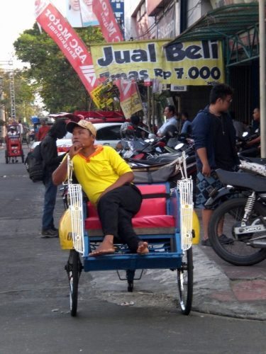 A pedicab awaits his fare.