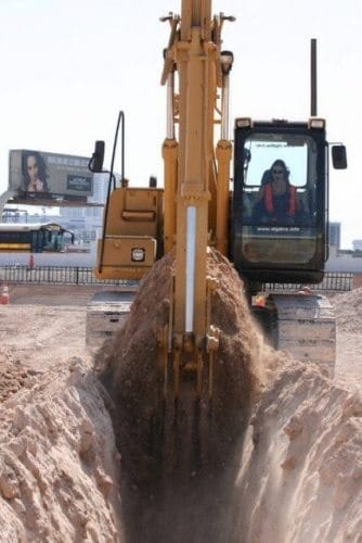 A woman digs a trench with an excavator at Dig This, in Las Vegas.